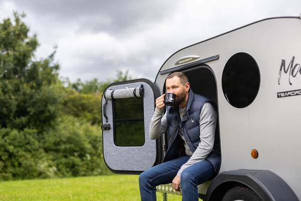 Man Drinking Tea In Camping Pod