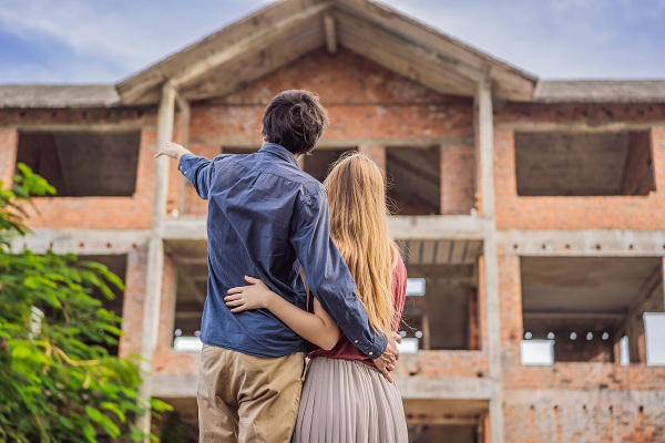 Couple outside new house build