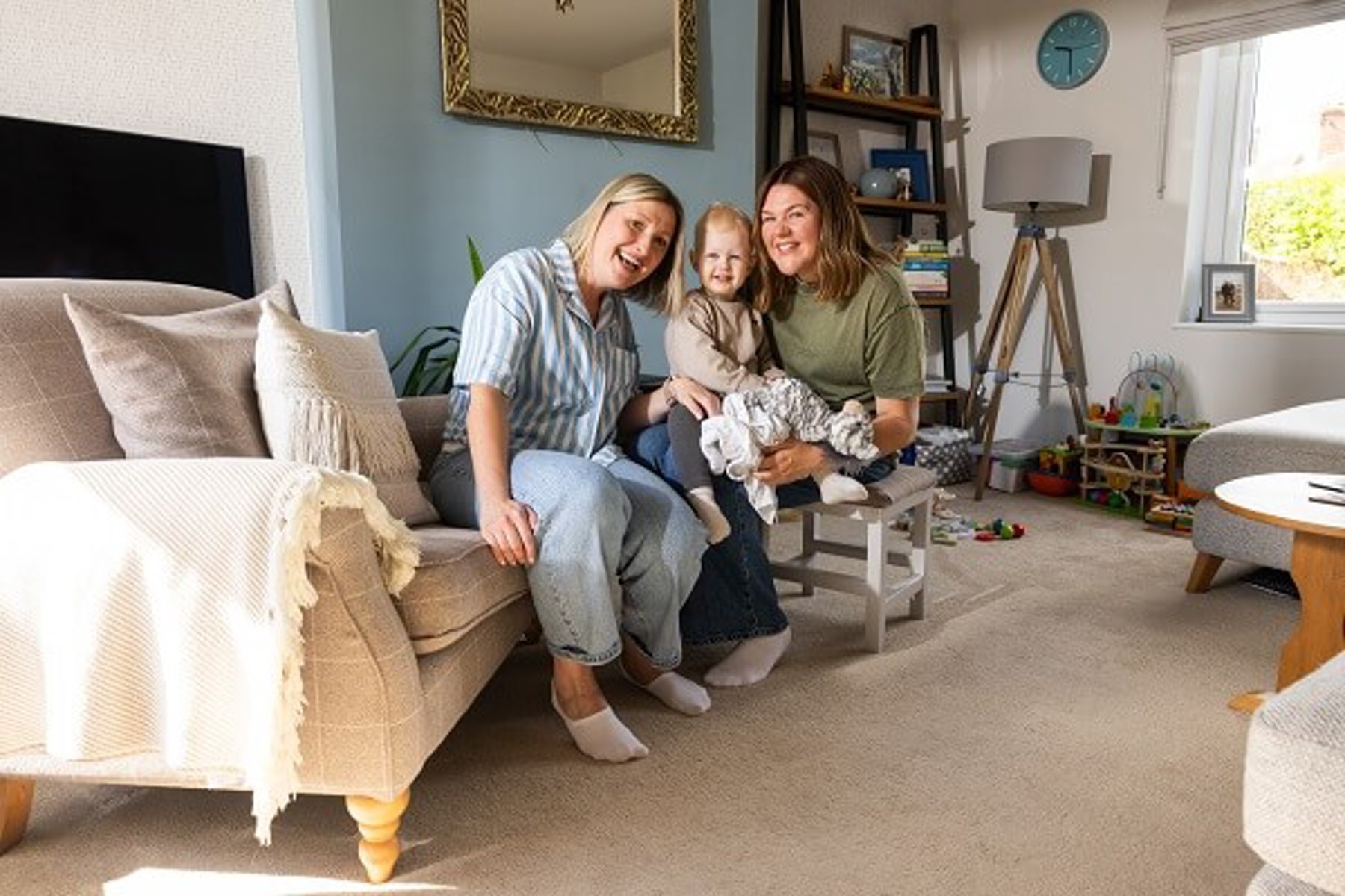 Couple In Living Room With Baby Toys