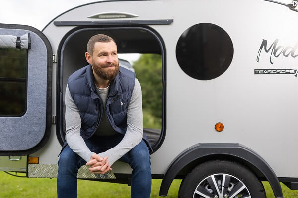 Man Looking In Sky Camping Pod