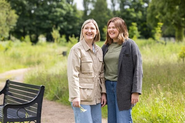 Couple Smiling Holding Daisy