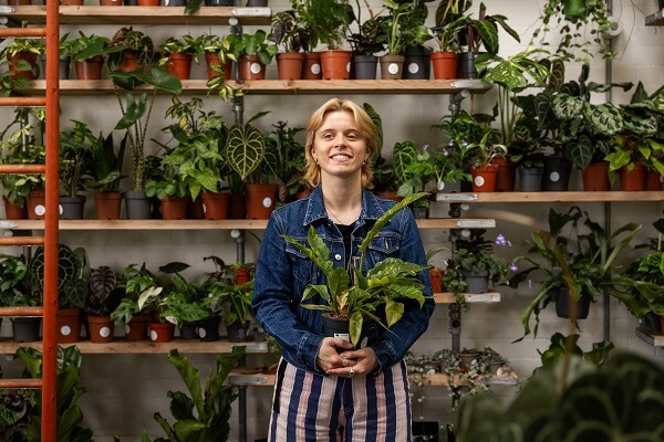 Woman In Demin Holding Plants