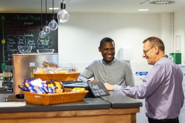 Two Colleagues At Kitchen