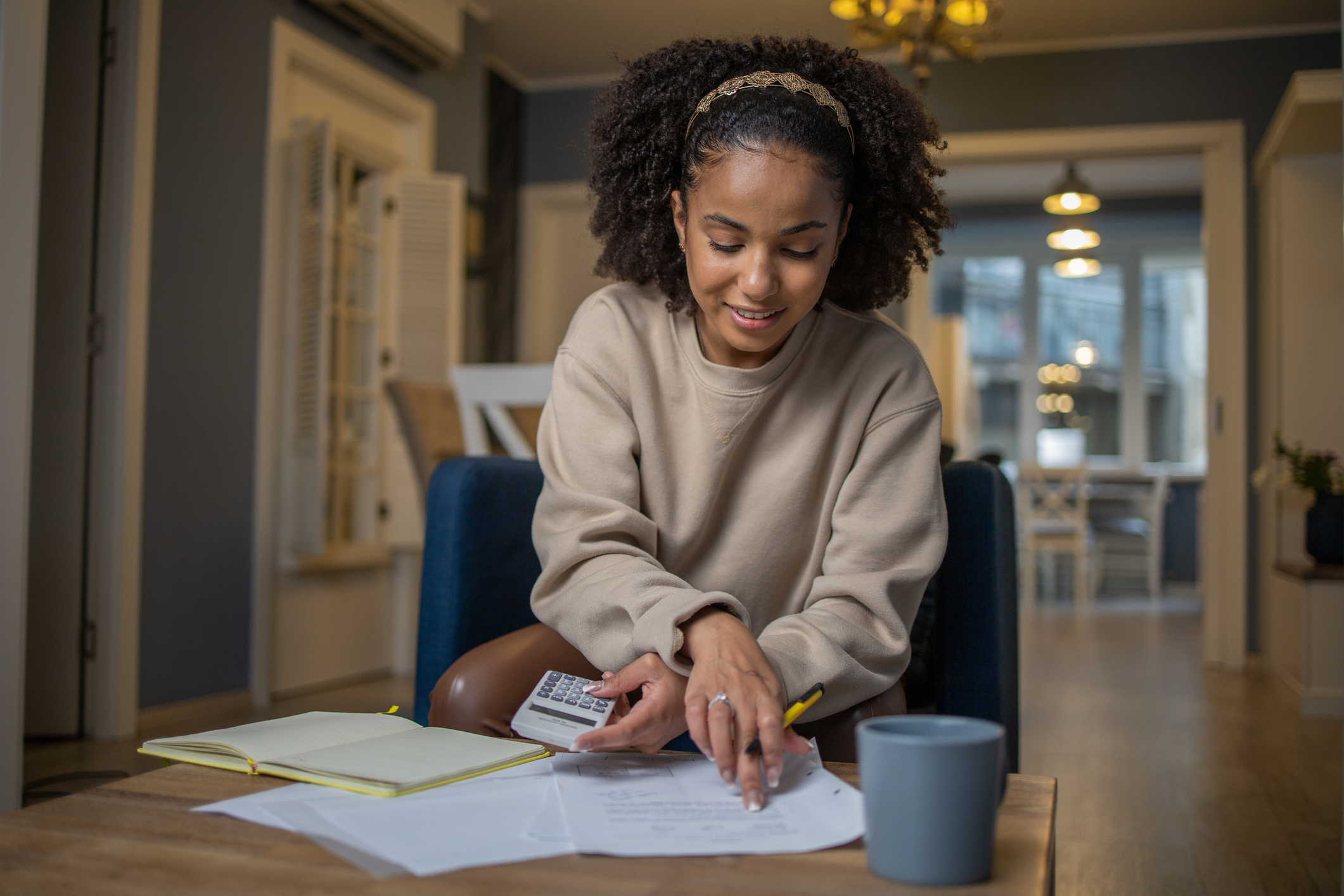 Women holding calculator looking at papers