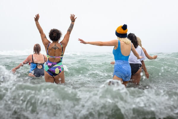 Women Walking Into Sea