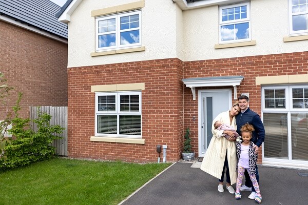 Coule Standing At New Home Front Door