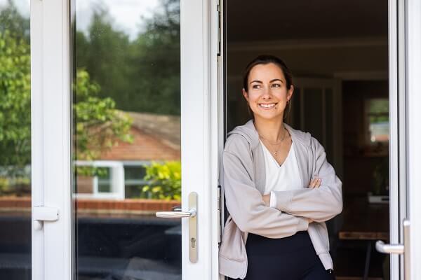 Woman Smiling At Conservatory Window