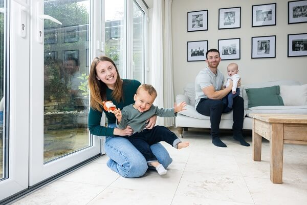 Family At Home In Living Room Smiling Toy