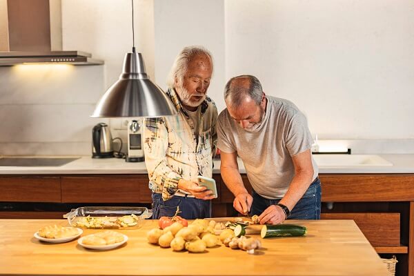 Two Men Chopping Vegetables