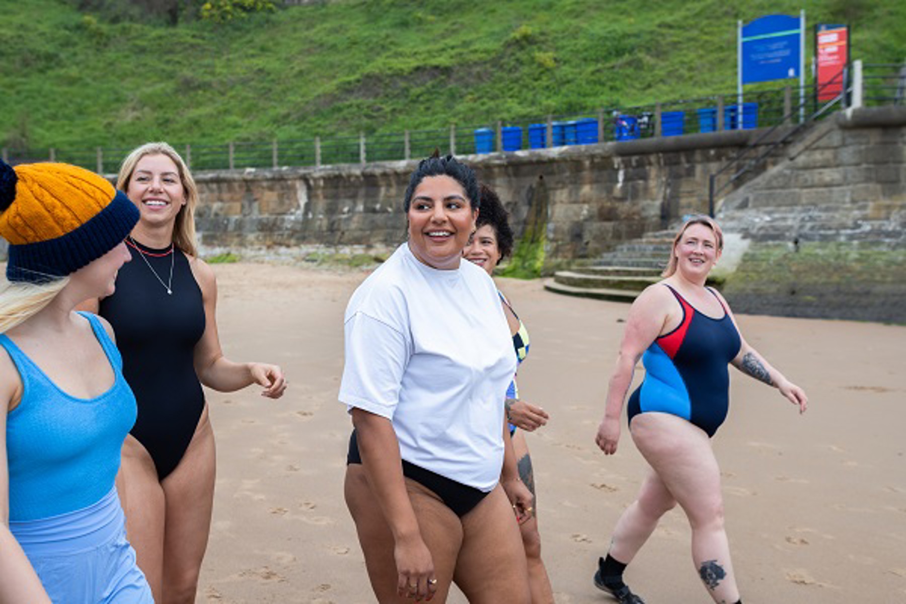 Women Walking On Beach Into Sea