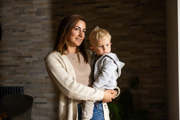 Woman Holding Baby In Conservatory