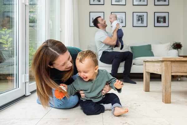 Woman Playing With Baby Man Holding Baby