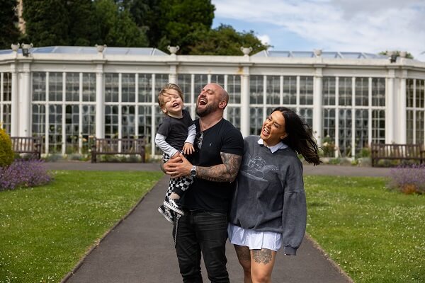 Couple Laughing With Child In Arms