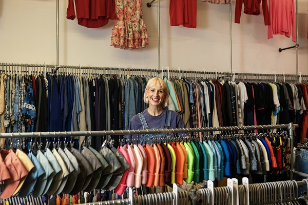 Woman Smiling In Clothes Shop Hats