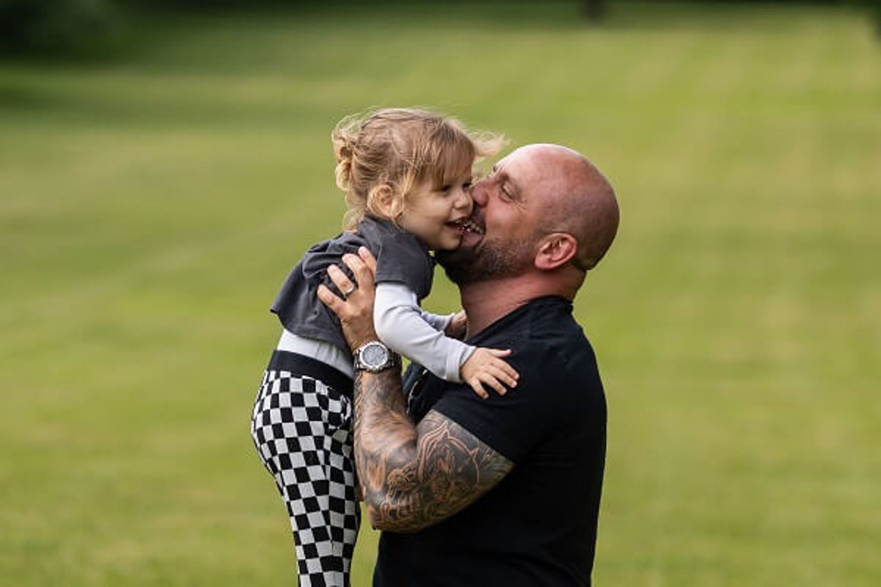 Man Black Tshirt Holding Baby In Air