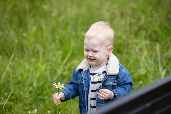 Baby Walking Holding Daisy